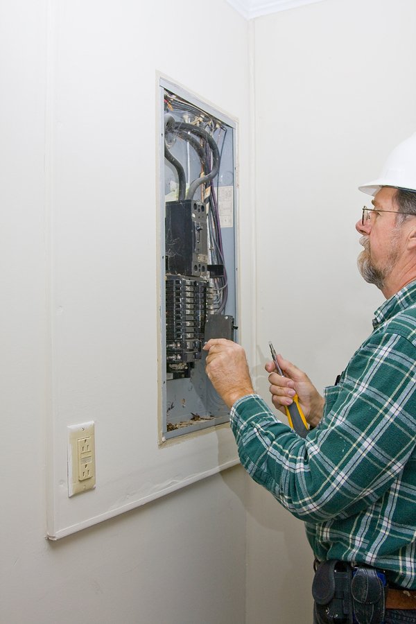 Man working on an electrical panel.